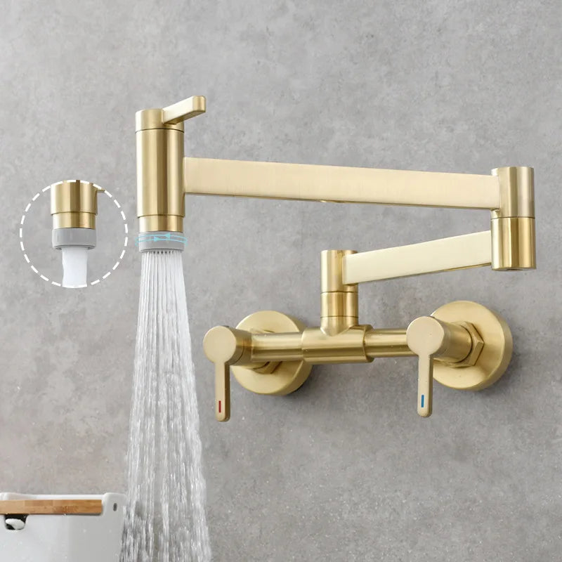 Gold-colored wall mounted single hole pot filler tap with foldable brushed gold brass spout and dual handles for kitchen use