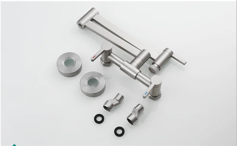 Stainless steel surgical instrument set with articulated arms alongside a wall mounted single hole brushed gold pot filler tap