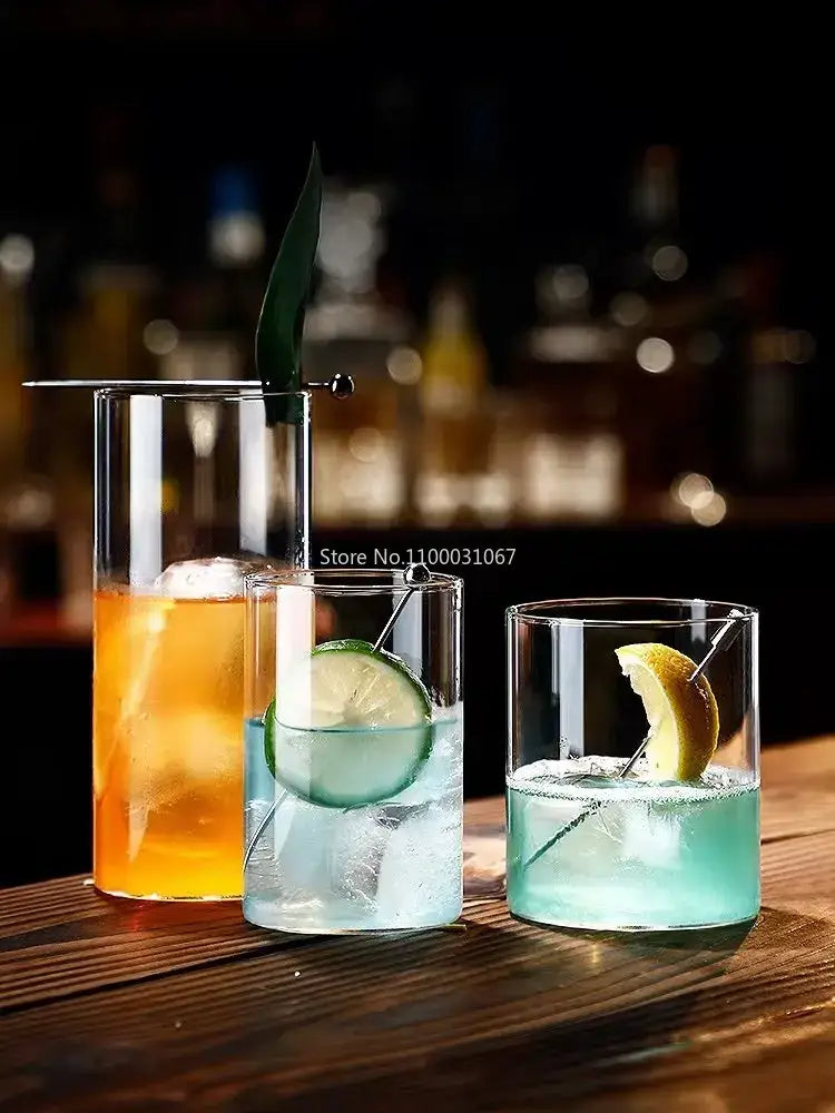Three clear glass highball cups filled with colorful cocktails garnished with citrus slices and ice cubes