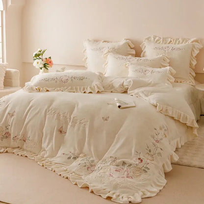 Cream-colored bedding set with delicate flowers embroidery ruffles and ruffled edges for elegant bedroom decor