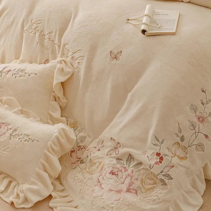 Cream-colored bedding set with flowers embroidery ruffles and delicate pastel accents for elegant bedroom decor