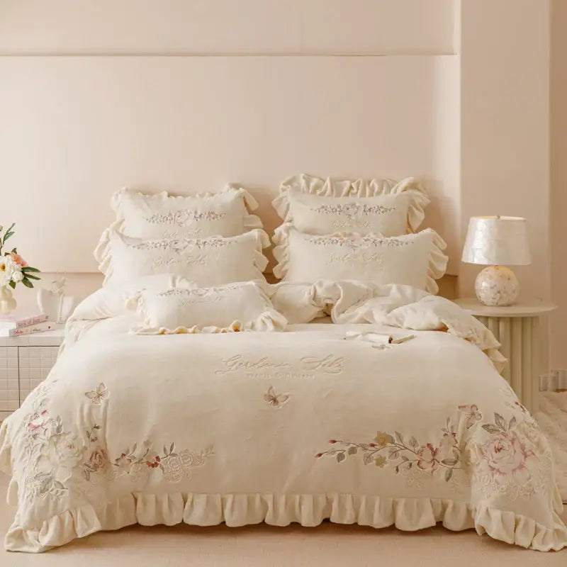 Cream-colored bedding set with flowers embroidery ruffles lace detailing and ruffled edges for elegant bedroom decor