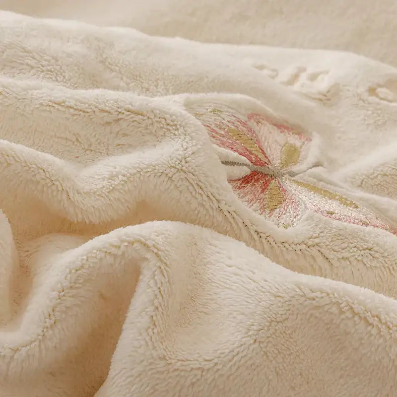 Cream-colored plush blanket with soft fuzzy texture and pink gold butterfly in princess cream flowers embroidery ruffles bedding set