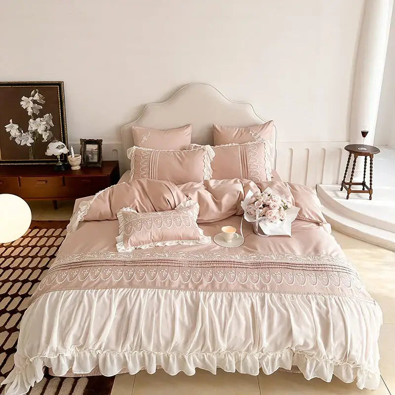 A soft blush pink satin bedding set with delicate white lace trim and decorbites flowers embroidery for princess wedding decor