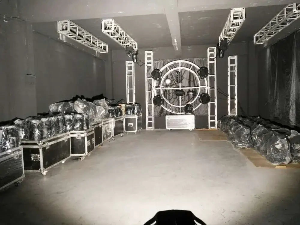 A circular metal frame stage lighting rig with multiple professional black 100w cob led par light spotlights mounted