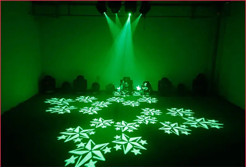 Green snowflake light projections from professional black decorbites 120w led moving head stage light in dark room