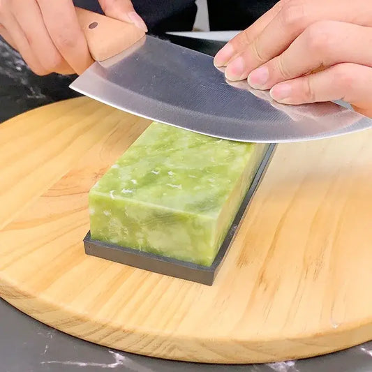Professional green stone knife sharpener set with black base used to hone a large metal cleaver edge decorbites sharpener set