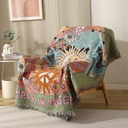 Cozy woven ethnic tapestry sofa blanket with psychedelic floral design and trust in yourself text on olive green border