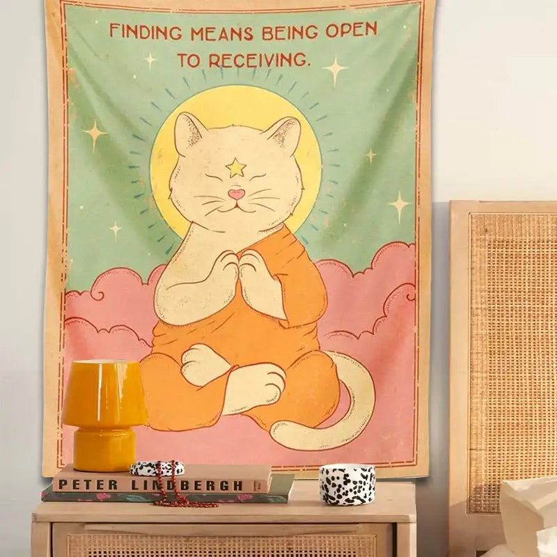 A soft pastel decorbites cat tapestry featuring an orange cat meditating with a yellow sun moon halo on mint green background