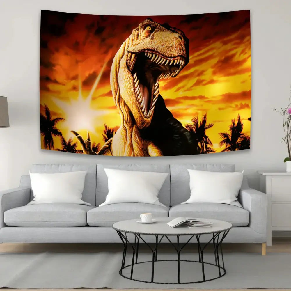 A vibrant orange and yellow decorbites dinosaur tapestry wall hanging with a roaring t-rex above a gray sofa