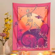 A vibrant pink and orange skeleton psychedelic tapestry featuring a dancing skeleton with bats and tombstones for decor