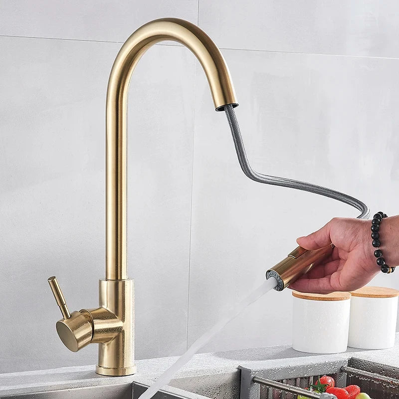 Gold-toned single hole pull out kitchen faucet with sleek curved spout and 360 rotation mixer tap for hot water use