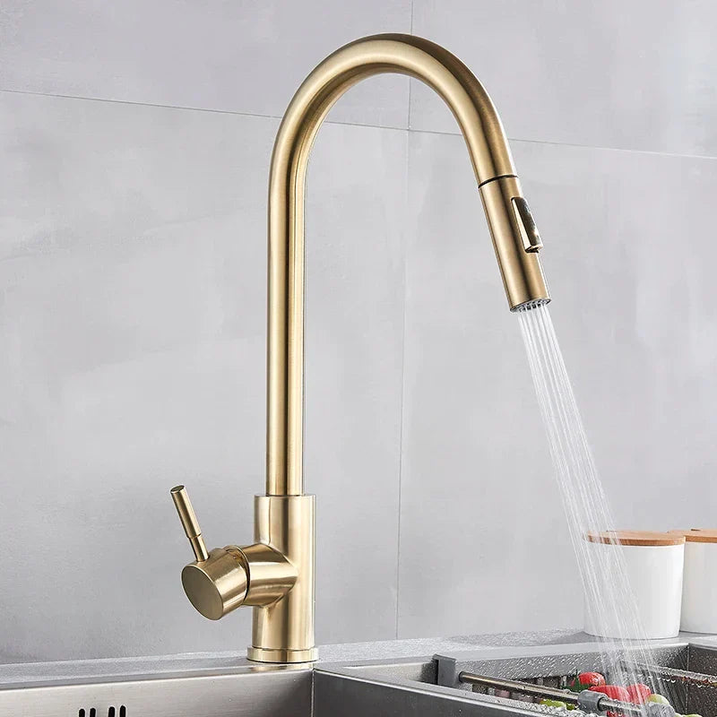 Brass-finished pull-down single hole kitchen mixer tap with sleek curved spout and single lever for hot water control