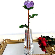 Purple and gold crystal rose figurine with sparkling petals green leaves and gold-toned stem in a glass vase