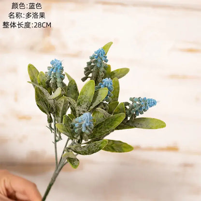 A blue artificial grape hyacinth fake green plants bouquet with green leaves for wedding decor made of synthetic materials