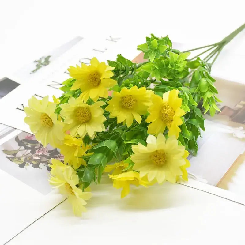 A bouquet of artificial yellow daisies with green stems and leaves as a green plant synthetic arrangement for living room