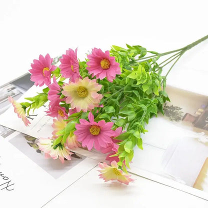 A bouquet green plant featuring artificial pink and cream daisies with yellow centers and green stems for living room decor