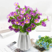 A purple and yellow daisy bouquet green plant synthetic flowers arranged in a white geometric patterned vase for living room