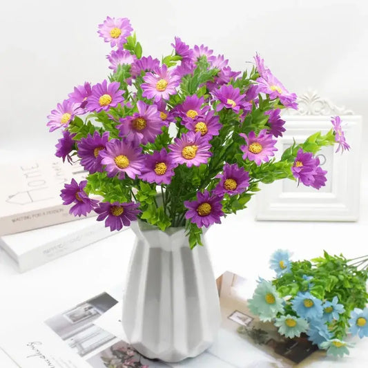 A purple and yellow daisy bouquet green plant synthetic flowers arranged in a white geometric patterned vase for living room