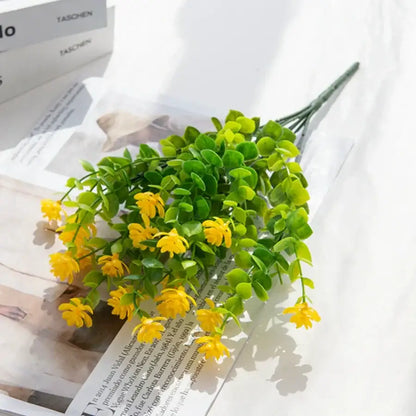 A vibrant yellow plastic flower bouquet with green leaves for decorbites artificial eucalyptus plant wedding decor