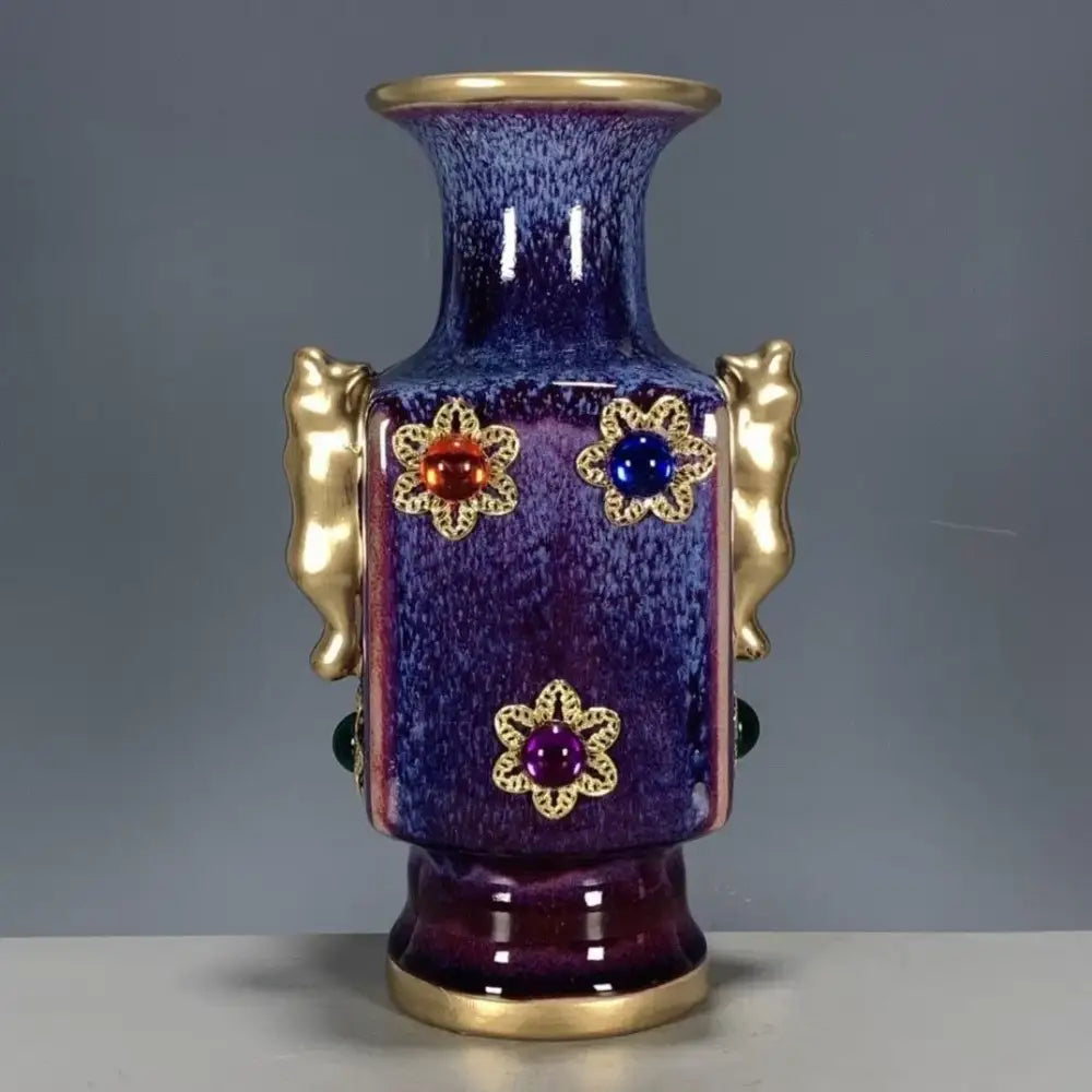 A glossy deep purple jun porcelain gilded gemstone vase with gold handles and floral motifs for living room decor