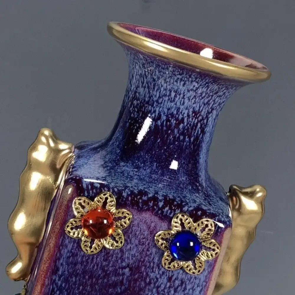 A glossy purple and blue jun porcelain gilded gemstone vase with gold handles and flower appliqués for living room decor
