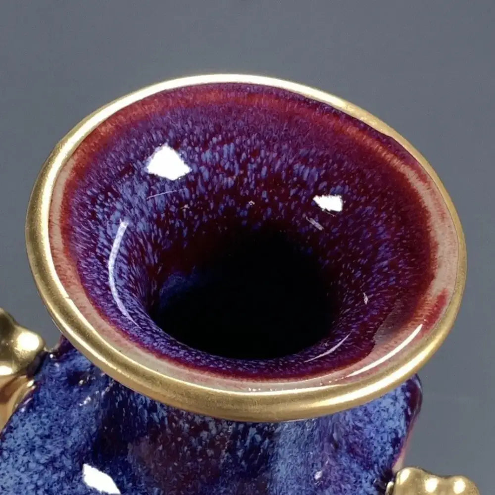 A ceramic jun porcelain gilded gemstone vase with deep purple and blue glaze and gold-toned rims for living room decor
