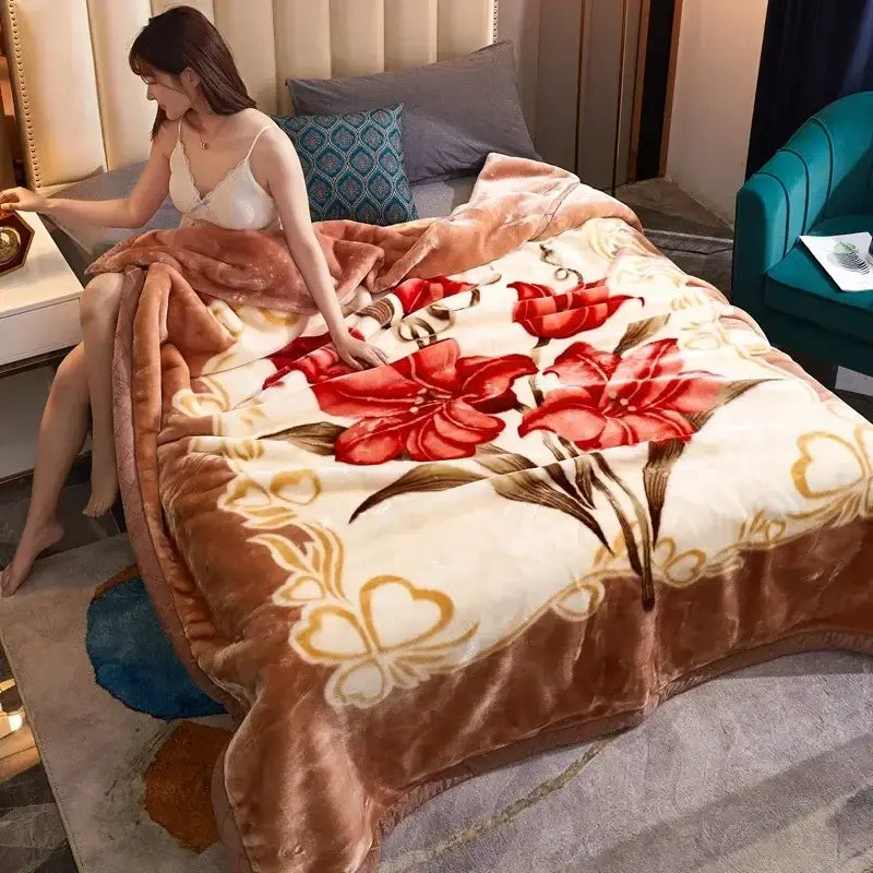 A cream-colored plush double layer raschel blanket with vibrant red floral patterns and gold accents for bedroom use