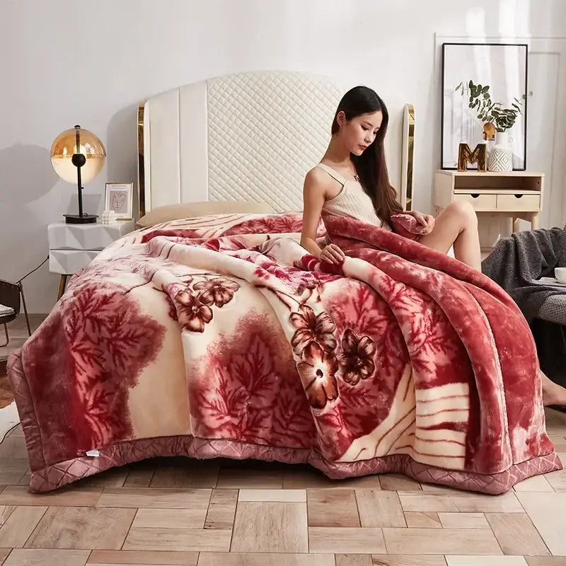 A plush red and cream floral double layer raschel blanket with soft velvety texture ideal for bedroom throws