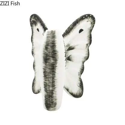 White and black butterfly-shaped decorative item with textured design for decorbites dark butterfly ceramic vase decor