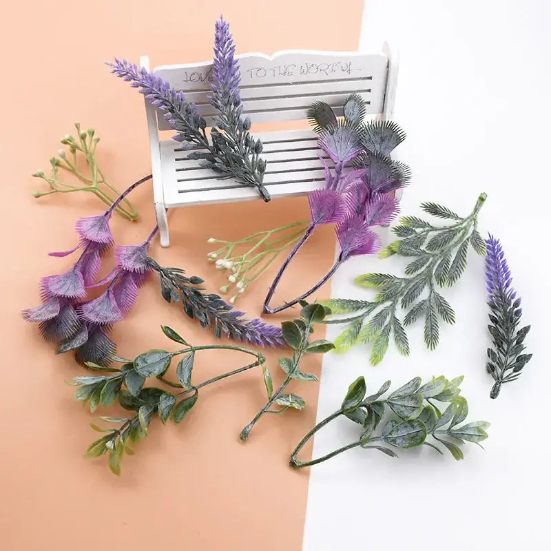 Purple and green detailed artificial plants with textured leaves arranged around a white bench for decorbites 10pcs plastic grass living room decor