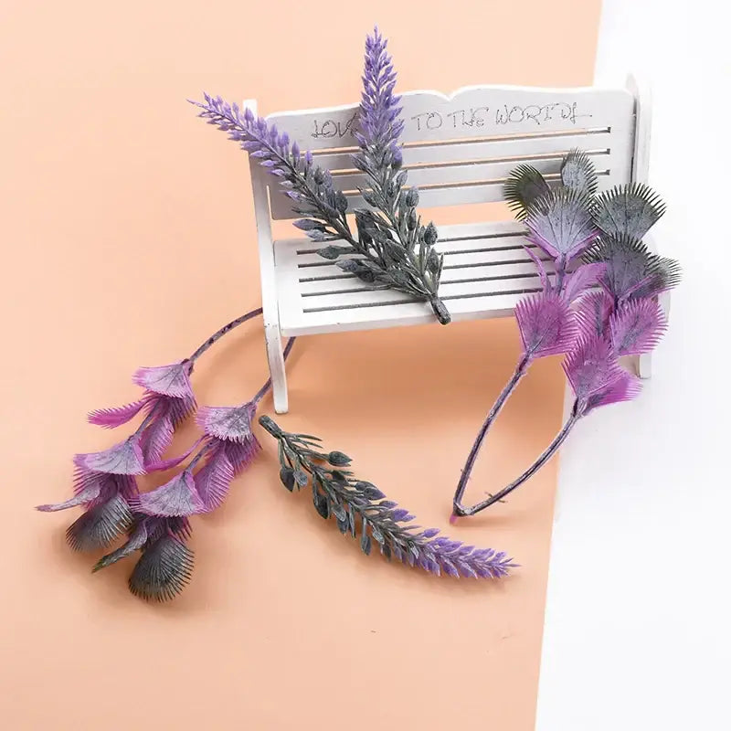 Purple and gray artificial lavender sprigs with feathery foliage on a miniature bench from decorbites 10pcs plastic grass set