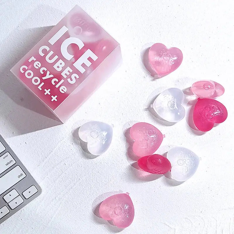 Purple heart ice cube mold reusable tray with pink and clear heart-shaped ice cubes and translucent pink box labeled ice cubes recycle cool++
