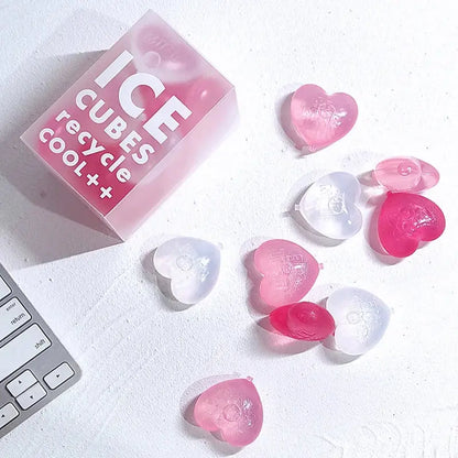 Purple heart ice cube mold reusable tray with pink and clear heart-shaped ice cubes and translucent pink box labeled ice cubes recycle cool++