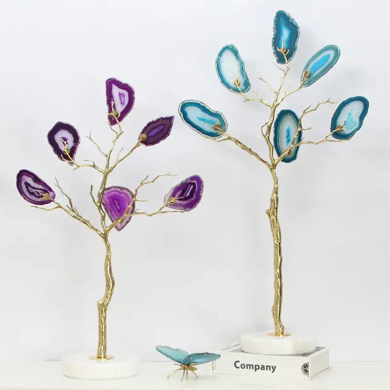 Two decorative purple and teal agate tree metal sculptures with gold branches on white marble bases for living room decor