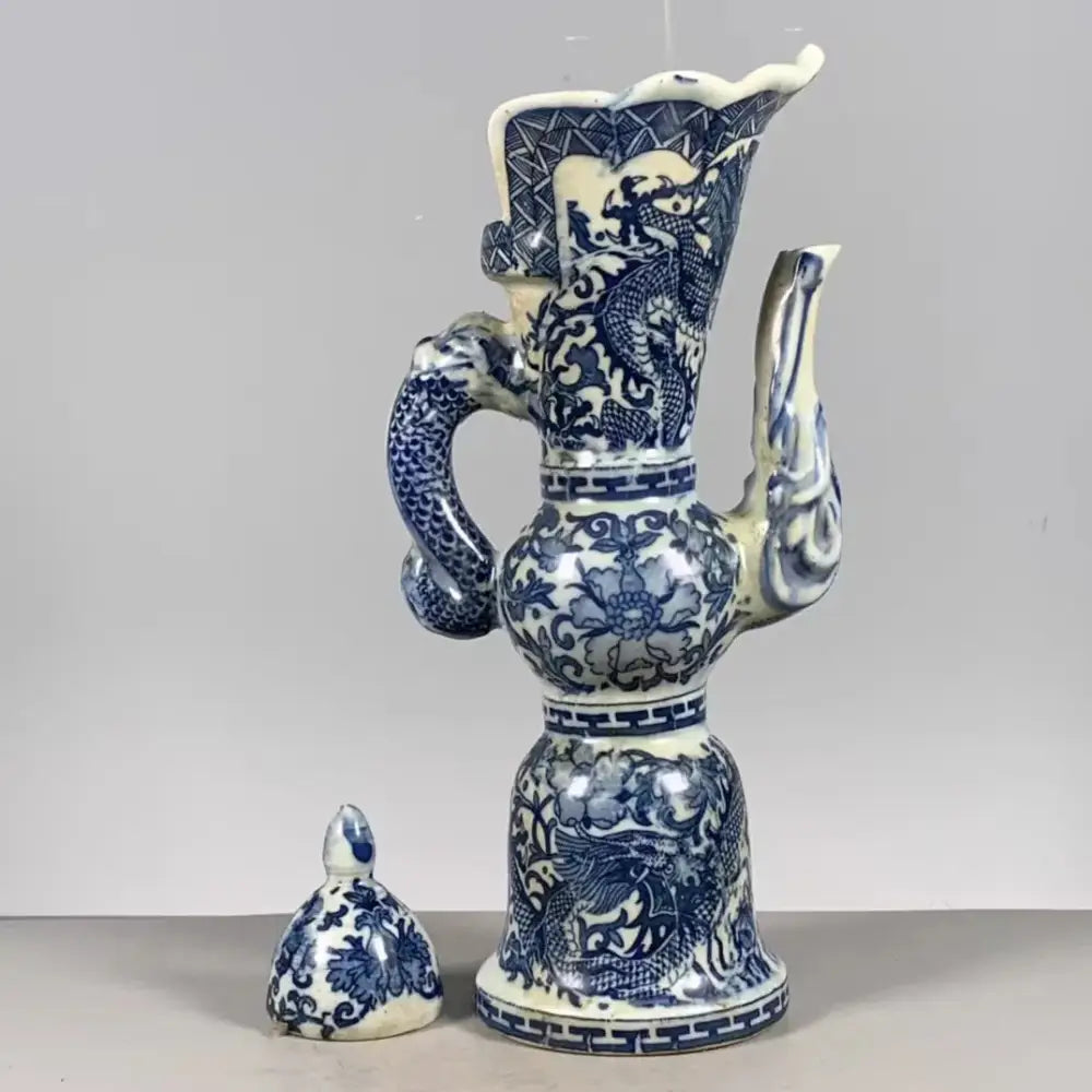 Qing blue and white porcelain ewer with intricate white dragon pattern and serpentine handle for living room decor