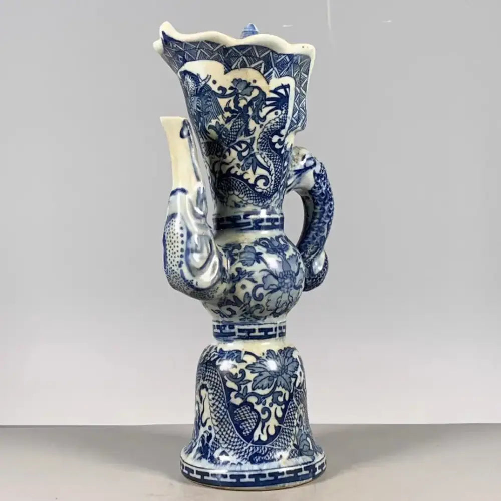 Qing blue and white porcelain vase with intricate white dragon pattern and fluted rim for living room decor