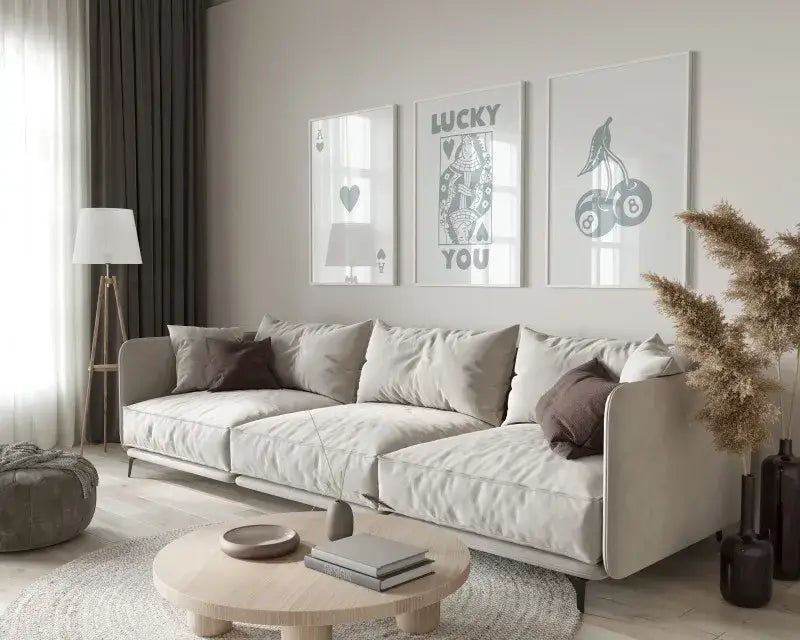 Beige upholstered sectional sofa with soft rounded armrests paired with retro queen wall art posters by DecorBites