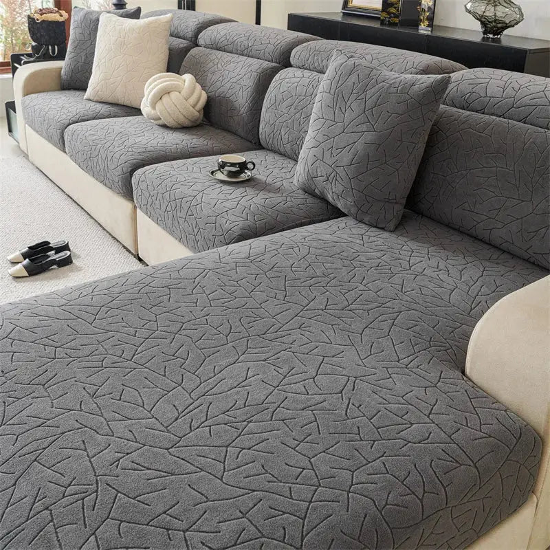 Gray textured sofa cover with subtle cracked pattern complements quilted beige leaf pattern elastic living room sofa cover