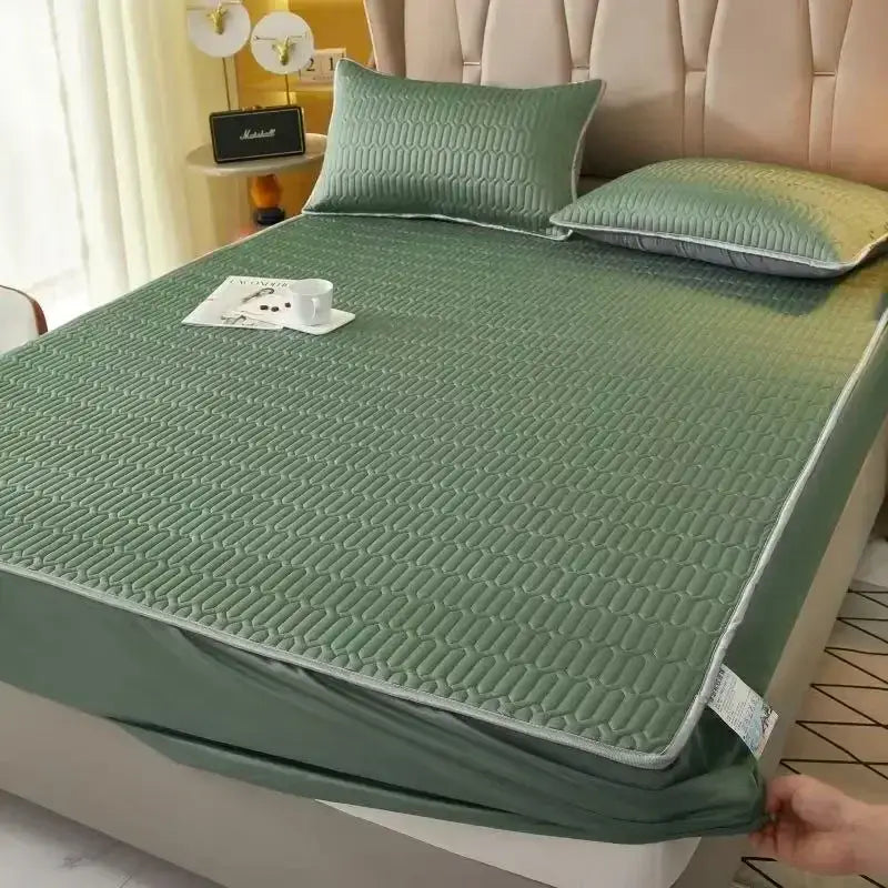 Green quilted fitted sheet set with subtle gradient and matching pillowcases for cooling mattress protection
