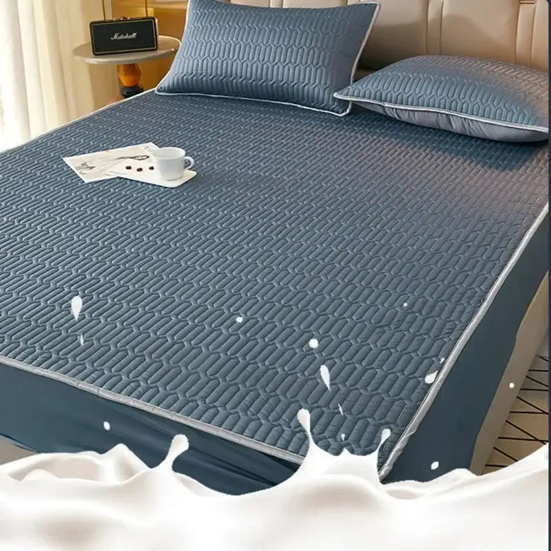 Blue quilted latex fitted sheet set with subtle geometric pattern and stitched edges for cooling mattress protection