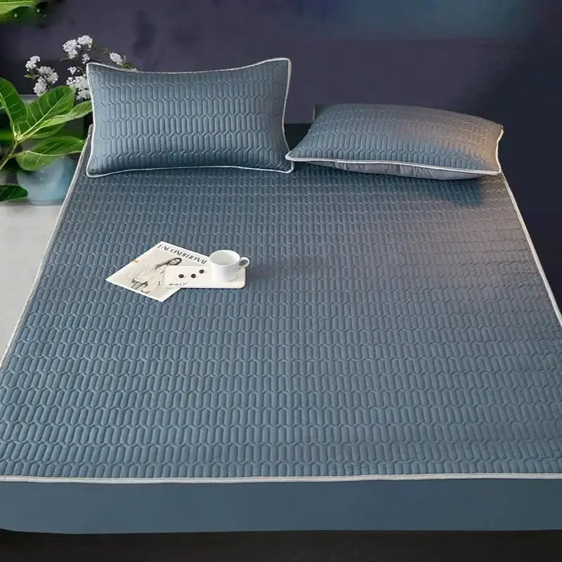 Blue quilted latex fitted sheet set with subtle geometric pattern and white piping for cooling mattress protection