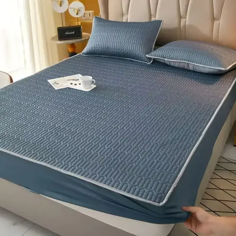 Quilted blue latex fitted sheet set with subtle geometric pattern and light gray piping for cooling mattress pad