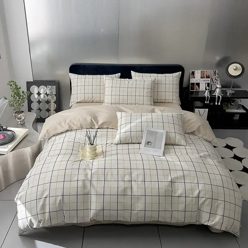 Cream-colored quilted bed set with black geometric printed pattern and soft textured fabric, including matching pillows