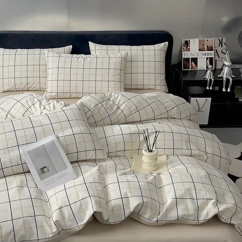 Quilted cream and black geometric printed bed set with soft cotton fabric and neatly arranged pillows for bedroom use