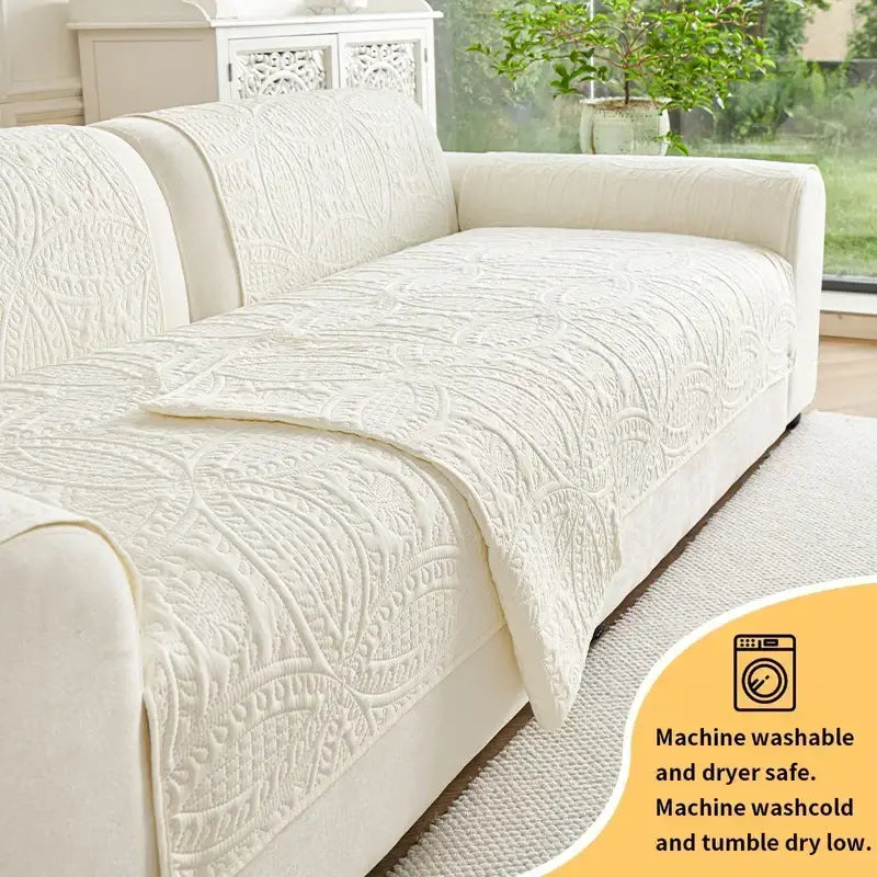 Cream-colored quilted sofa cover with intricate floral embroidery for living room cushions
