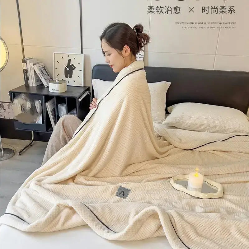 Cream-colored plush blanket with black trim made of decorbites cozy cotton velvet for bedroom comfort