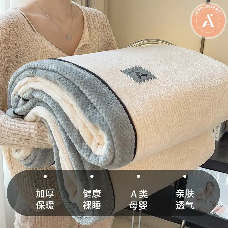 A plush cream and gray blanket with black trim made of cozy cotton velvet from decorbites for bedroom comfort