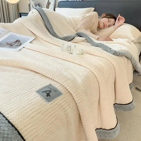 Cream-colored plush blanket with gray trim quilted texture and branded patch made of decorbites cozy cotton velvet
