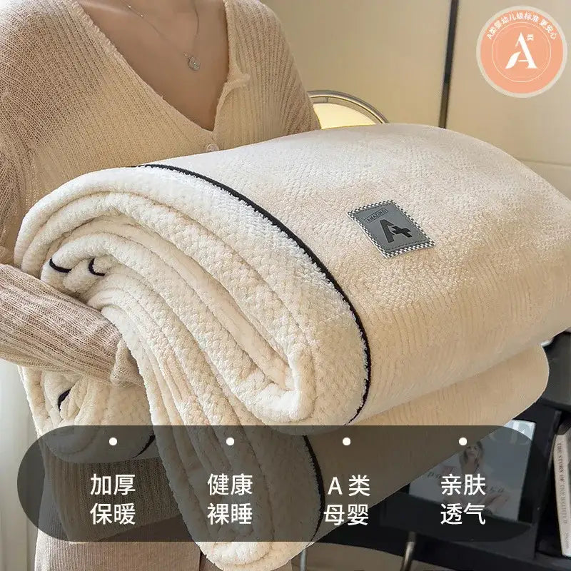 Cream-colored plush blanket with black trim featuring cozy cotton velvet texture from decorbites cozy cotton collection